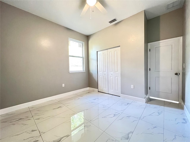 unfurnished bedroom featuring a closet, ceiling fan, and light tile floors