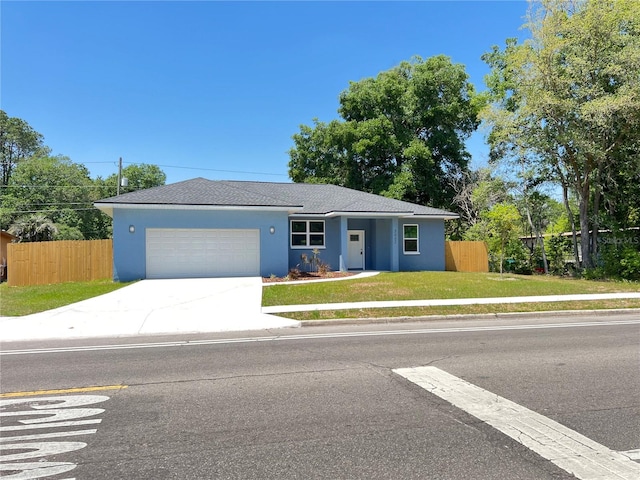 single story home featuring a garage and a front yard