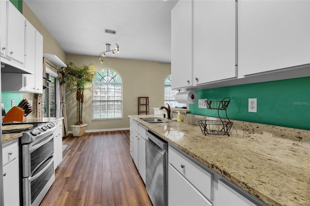 kitchen with sink, light stone counters, dark hardwood / wood-style flooring, white cabinets, and appliances with stainless steel finishes