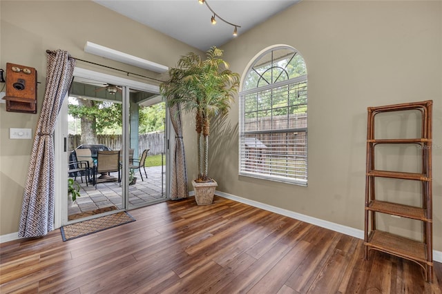 doorway featuring lofted ceiling, hardwood / wood-style floors, and ceiling fan