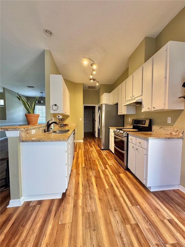 kitchen featuring sink, white cabinets, light stone counters, light hardwood / wood-style floors, and stainless steel appliances