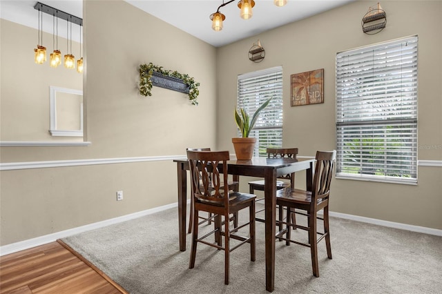 dining room with hardwood / wood-style flooring and a notable chandelier