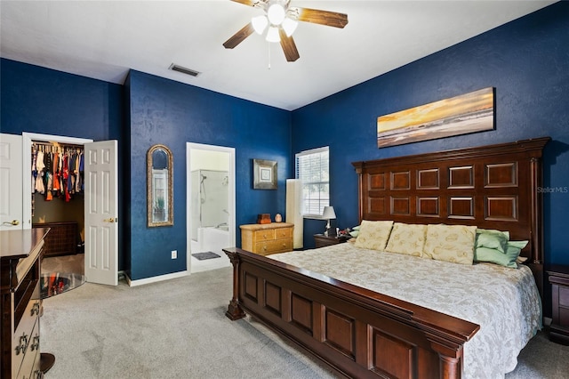 carpeted bedroom with ceiling fan, a closet, and ensuite bathroom