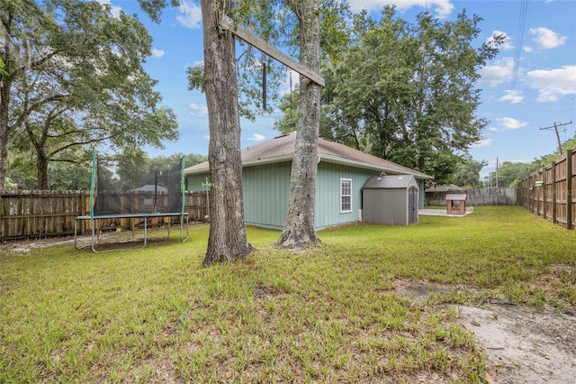 view of yard featuring a storage shed and a trampoline