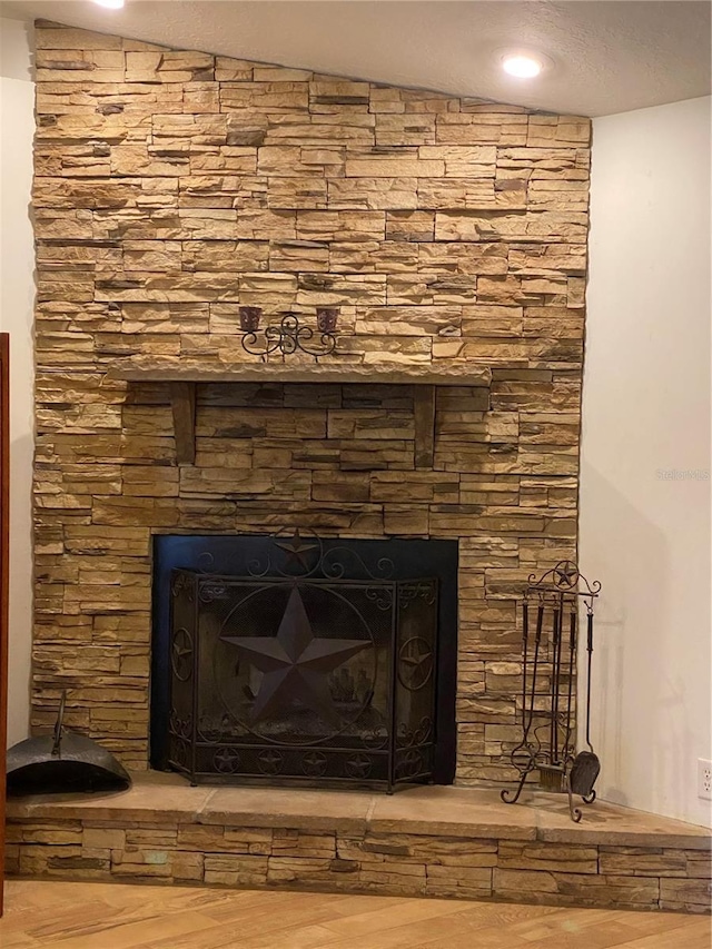 details with wood-type flooring and a fireplace