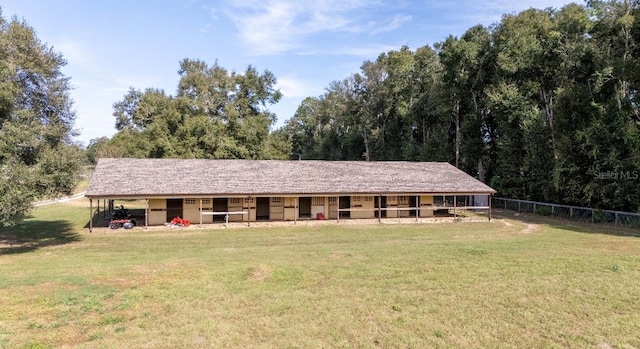 ranch-style home featuring an outbuilding