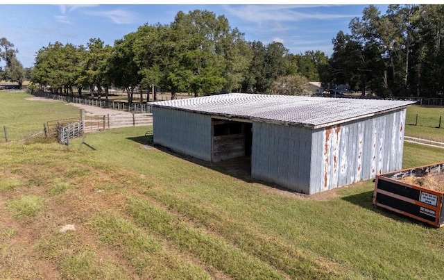 view of outbuilding with a yard and a rural view