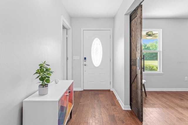 entrance foyer featuring dark hardwood / wood-style floors and a barn door