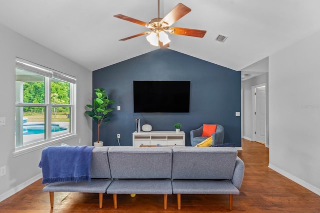 living room with ceiling fan, wood-type flooring, and vaulted ceiling