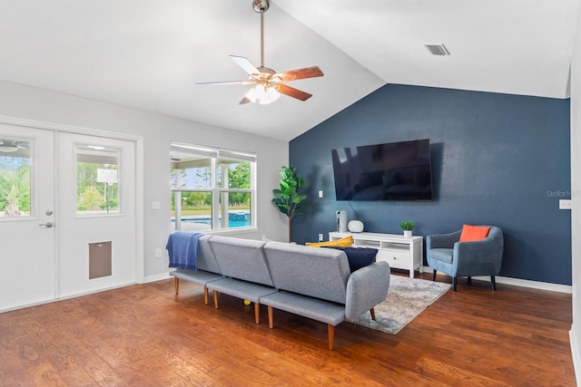 living room featuring hardwood / wood-style floors, vaulted ceiling, and ceiling fan