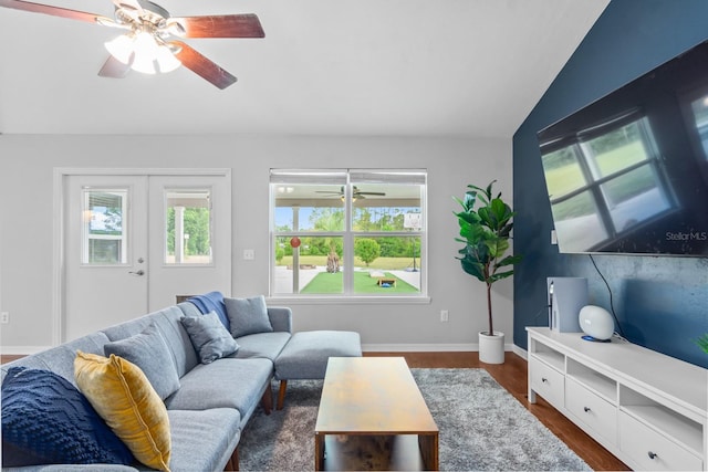 living room with french doors, dark hardwood / wood-style flooring, and vaulted ceiling