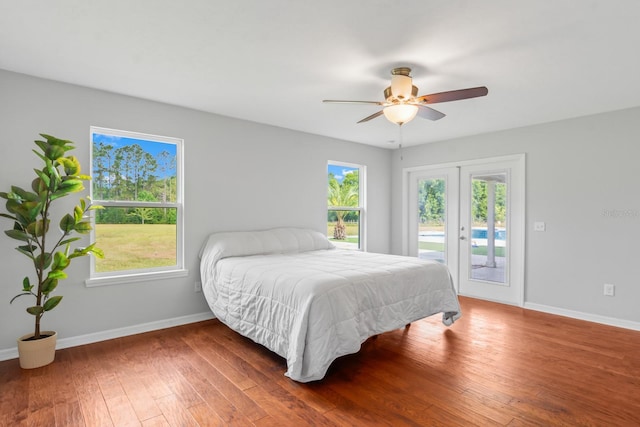 bedroom with ceiling fan, dark hardwood / wood-style flooring, access to outside, and french doors