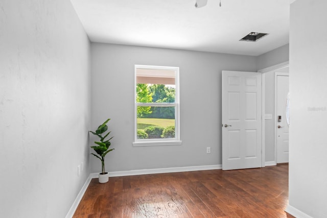 spare room with dark hardwood / wood-style flooring