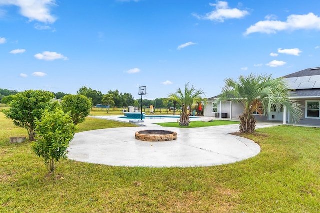 exterior space featuring a lawn, a patio area, and a pool