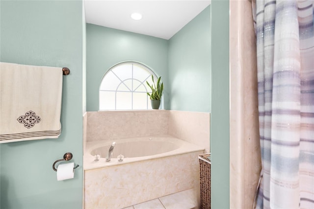 bathroom featuring tile patterned floors and a bath
