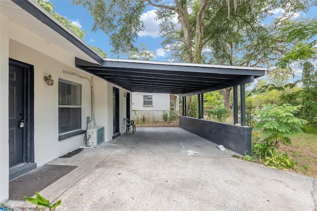 view of patio / terrace with ac unit and a carport