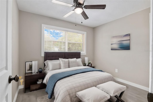 bedroom with hardwood / wood-style flooring and ceiling fan