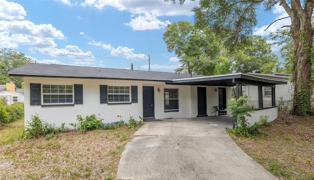 919 SE 19th St, Gainesville, FL 32641 - ranch-style home with an attached carport, aphalt driveway, and stucco siding