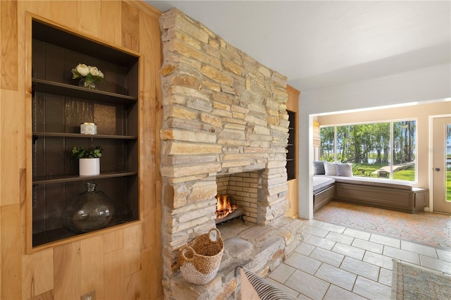 unfurnished living room featuring light tile floors and a fireplace