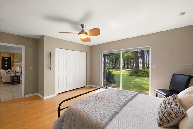 bedroom with ceiling fan, a closet, light hardwood / wood-style flooring, and access to outside