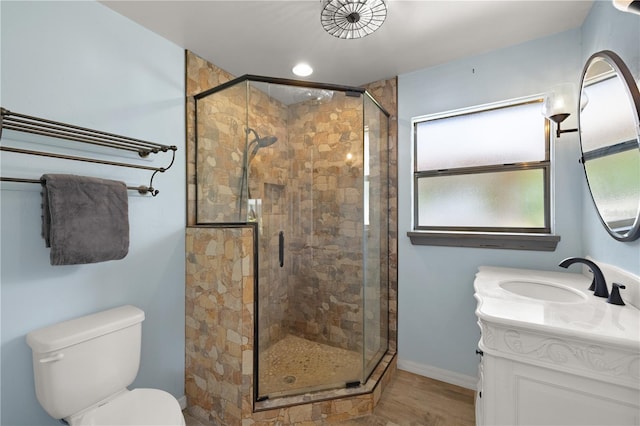 bathroom featuring a shower with shower door, vanity, toilet, and hardwood / wood-style flooring