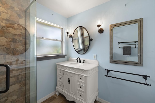 bathroom with hardwood / wood-style floors, an enclosed shower, and vanity