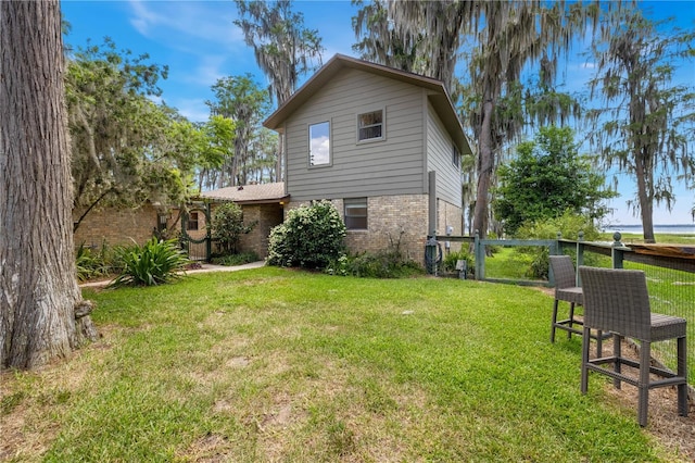 back of house featuring a lawn