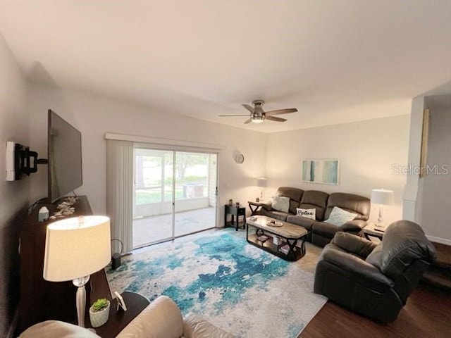 living room featuring wood-type flooring and ceiling fan