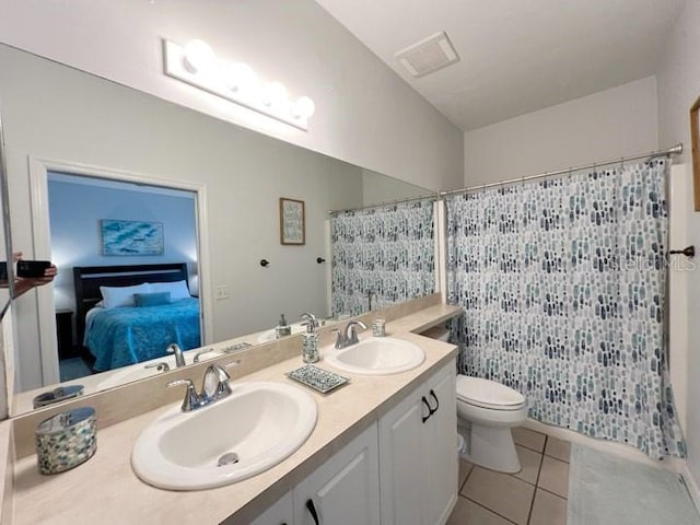 bathroom featuring vanity, toilet, curtained shower, and tile patterned flooring