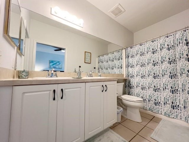 bathroom with tile patterned flooring, vanity, a shower with shower curtain, and toilet