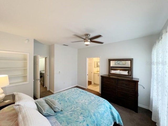 carpeted bedroom featuring connected bathroom, washer / clothes dryer, and ceiling fan