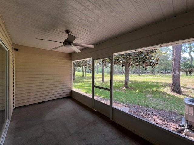 unfurnished sunroom with ceiling fan