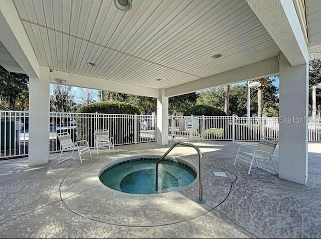 view of swimming pool with a hot tub and a patio