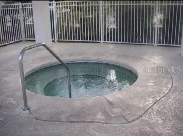 view of pool featuring a community hot tub and a patio area