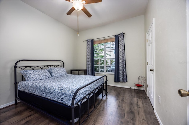 bedroom with ceiling fan, lofted ceiling, and dark wood-type flooring