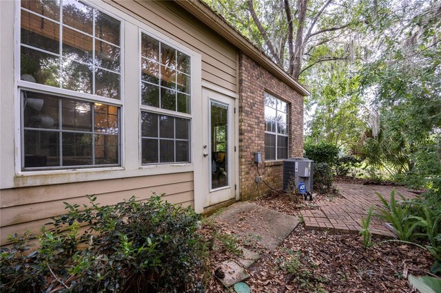 property entrance with a patio and central AC unit