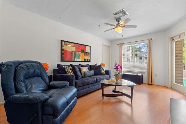 living room featuring hardwood / wood-style floors, a textured ceiling, and ceiling fan