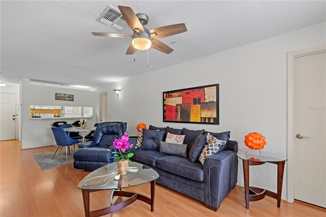 living room with hardwood / wood-style floors and ceiling fan