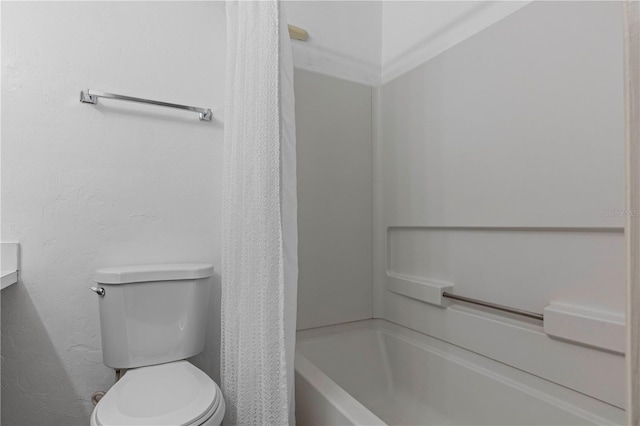 bathroom featuring toilet, ornamental molding, and tub / shower combination