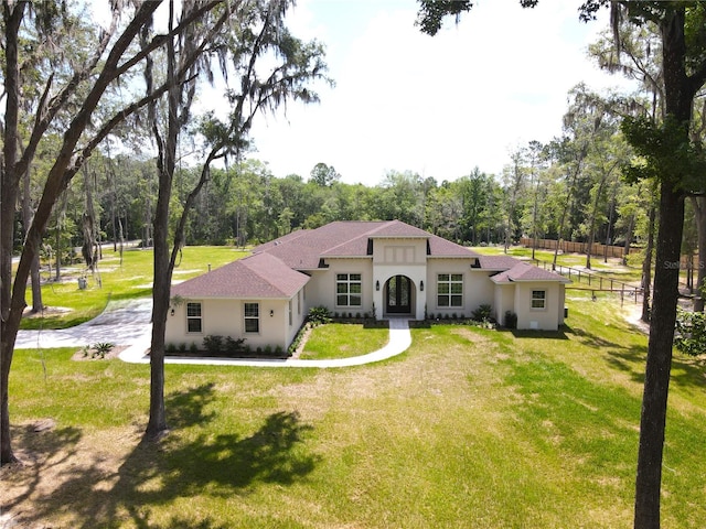 mediterranean / spanish-style home featuring a front lawn