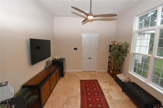 foyer entrance with ceiling fan