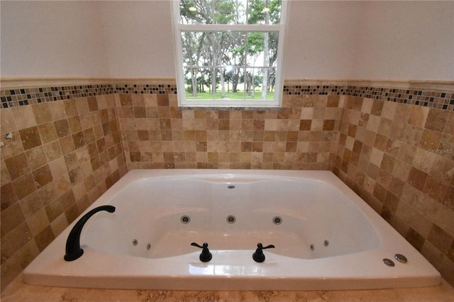 bathroom featuring tiled tub