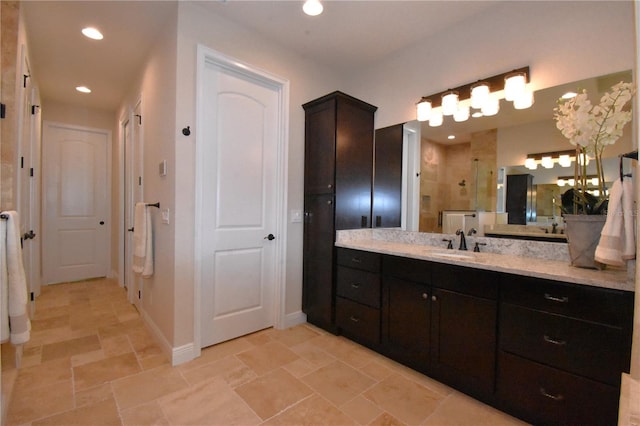 bathroom with walk in shower and vanity