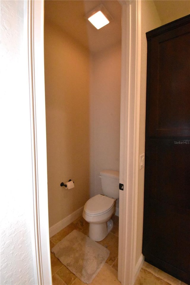 bathroom with tile patterned floors and toilet