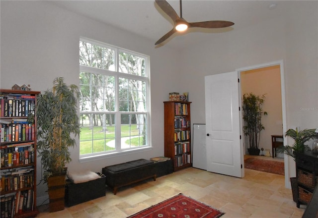 living area with a wealth of natural light and ceiling fan