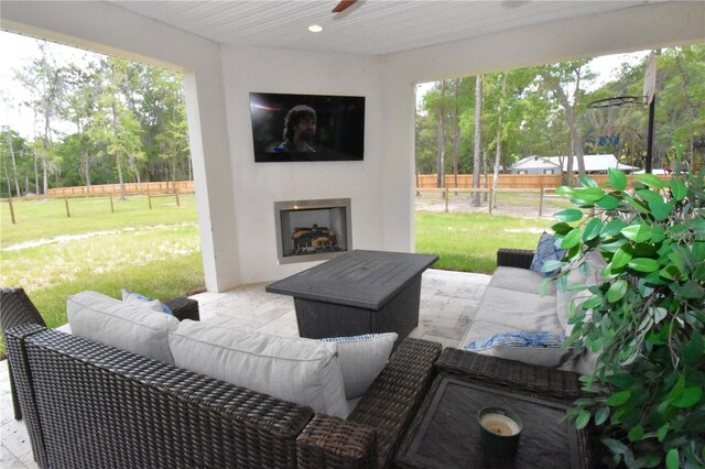 view of patio / terrace with an outdoor living space with a fireplace