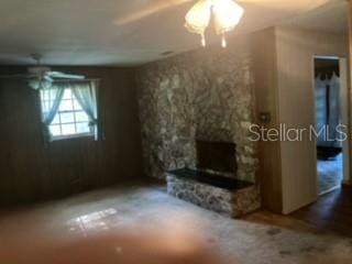 unfurnished living room featuring a fireplace and ceiling fan