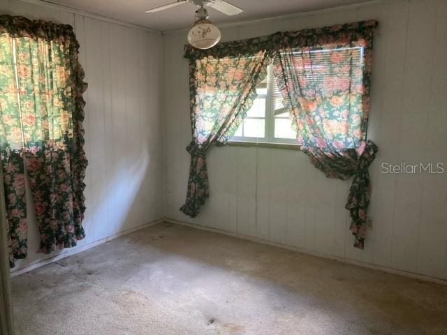 unfurnished room with ceiling fan