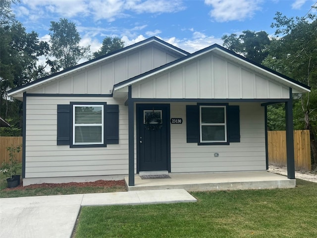 view of front of home with a front yard and a porch