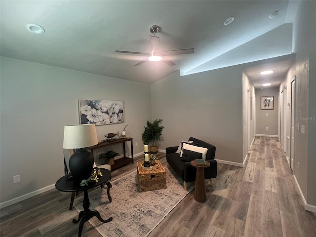 living area featuring ceiling fan, hardwood / wood-style floors, and lofted ceiling